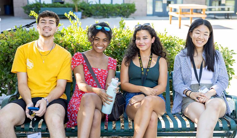 Harvey Mudd Students sitting on a bench.